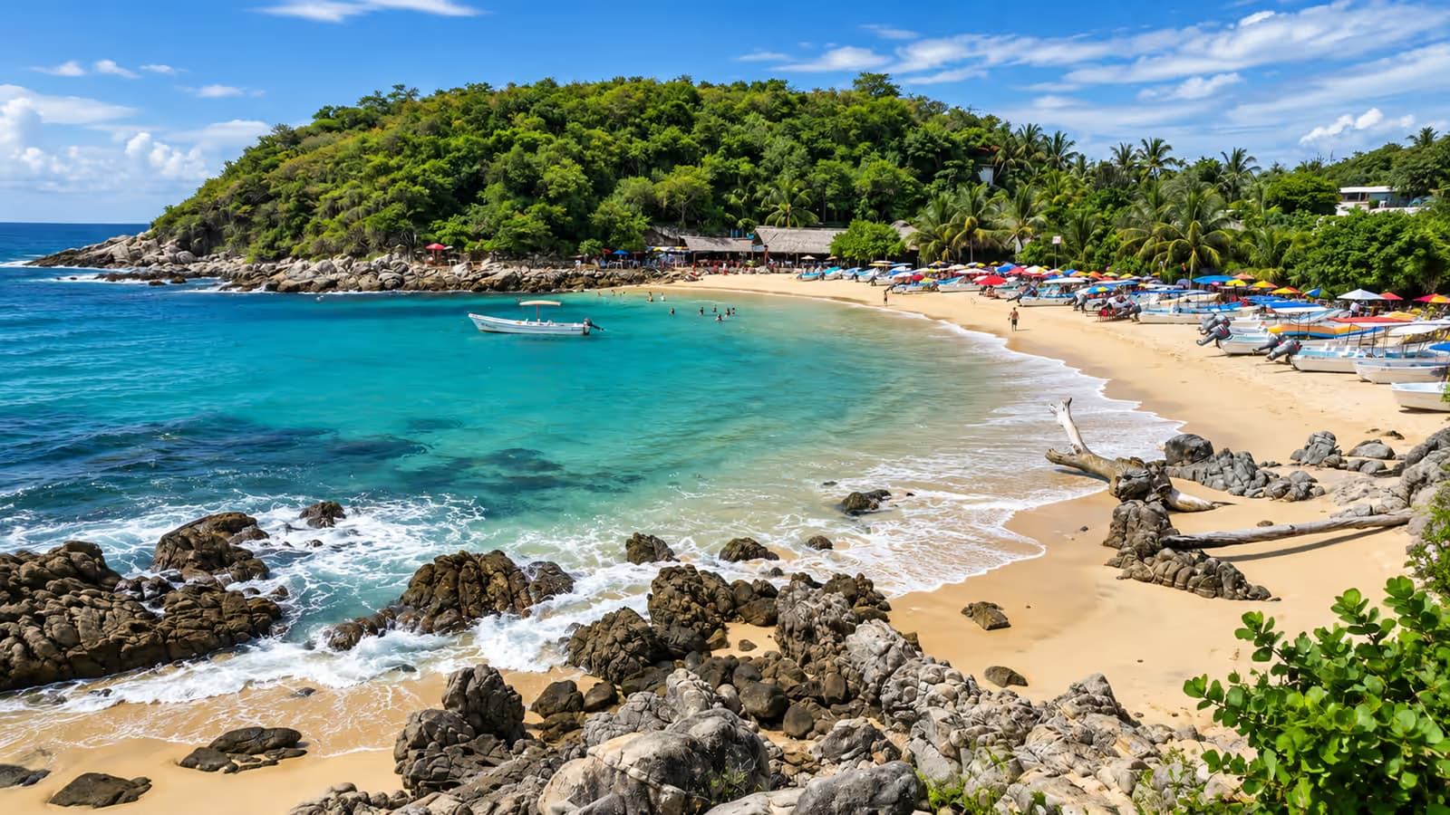 Turquoise bay with anchored boats and colorful umbrellas on the sand