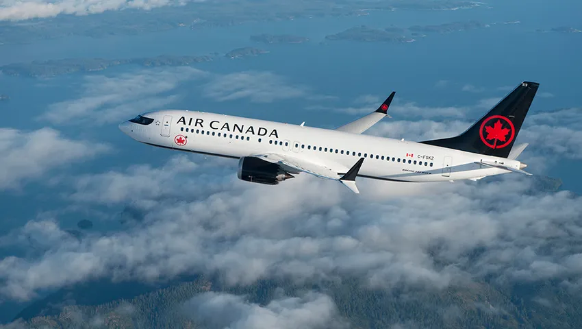 Air Canada plane in flight above a sea of clouds