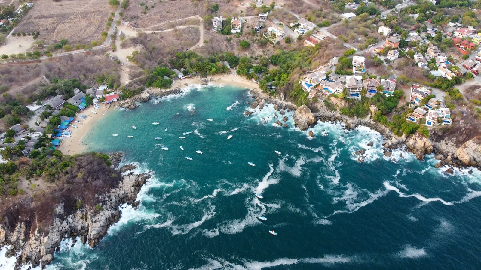 Aerial view of a Puerto Escondido bay with houses on the hillside